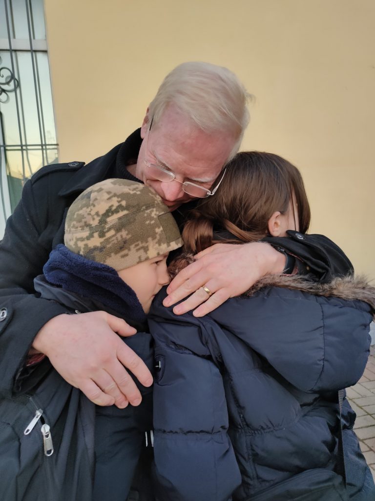 Frontier Horizon board member Mike Brady hugs Ukrainian kids good bye as they leave Camp Dreamland.